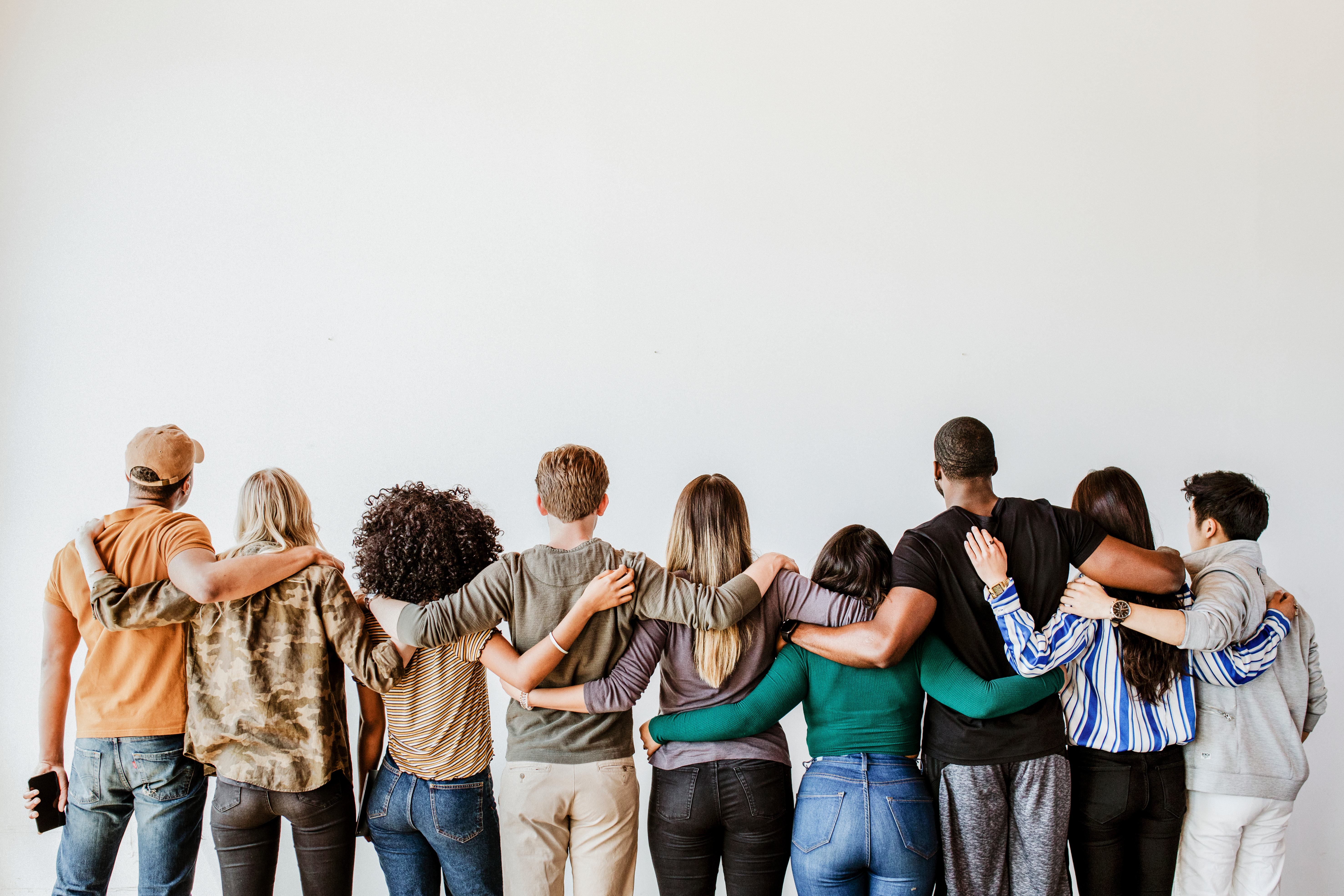Group of people standing together with arms folded