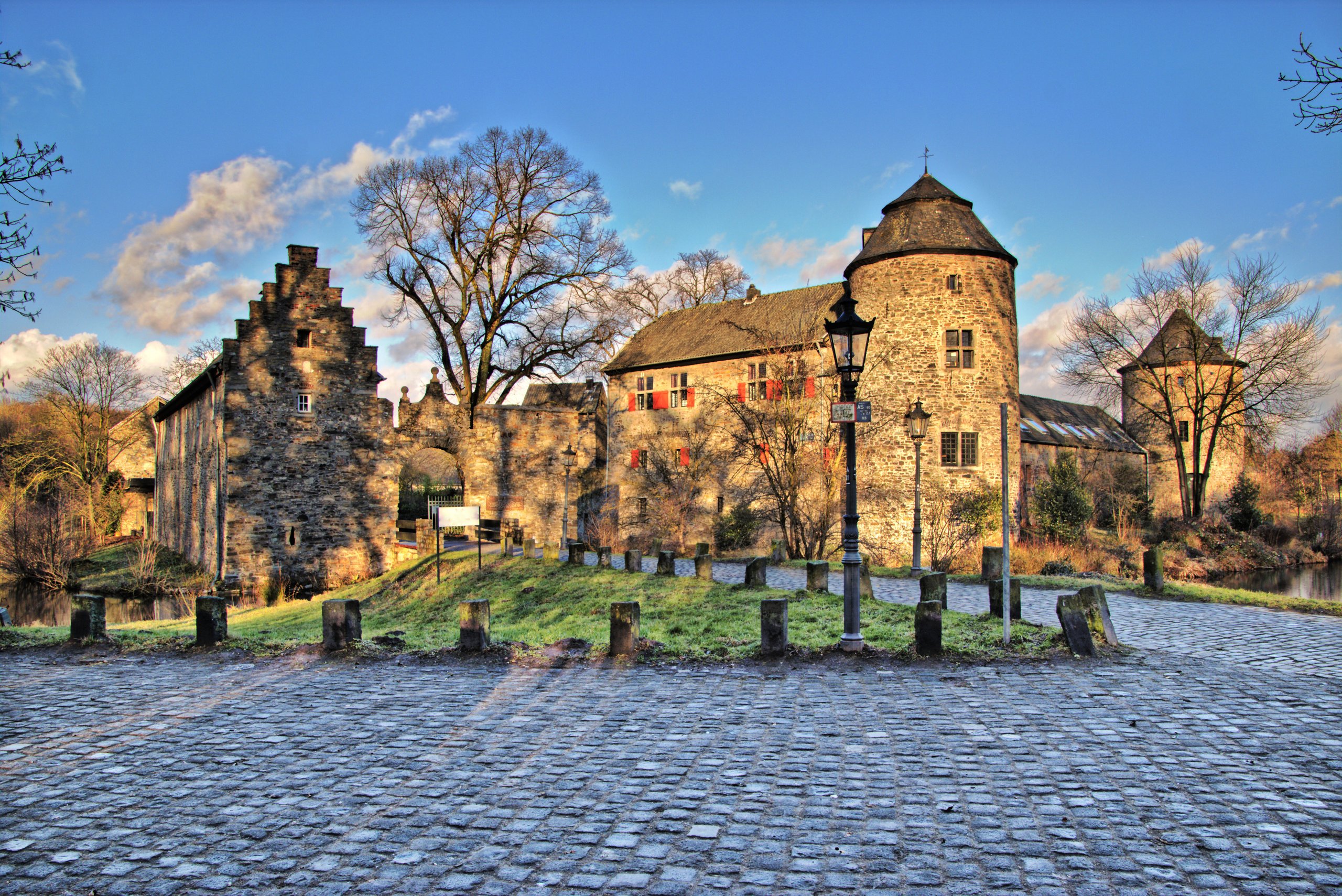 Historic castle with a tower by the water in sunshine