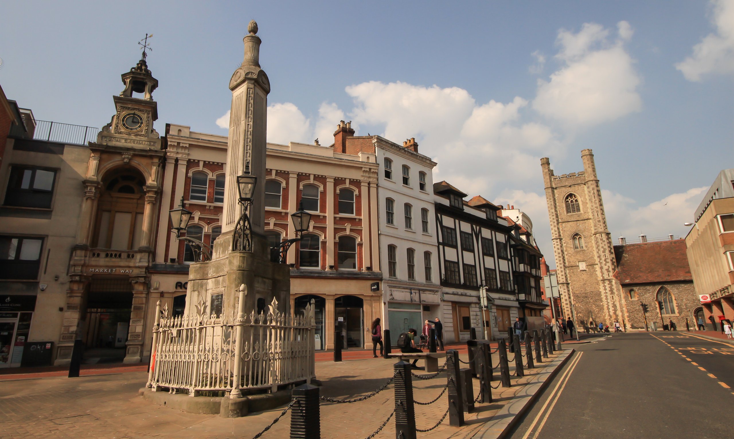 Historic market square with a monument, church and Georgian houses